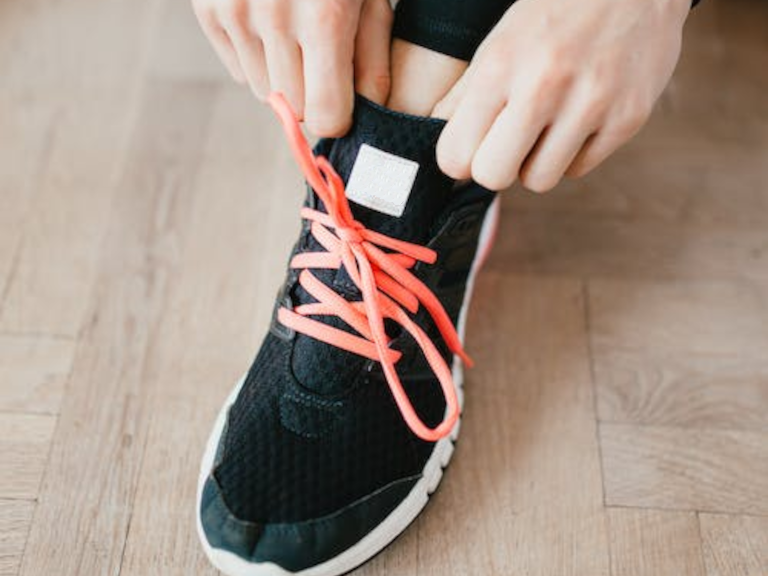 a person tying shoes